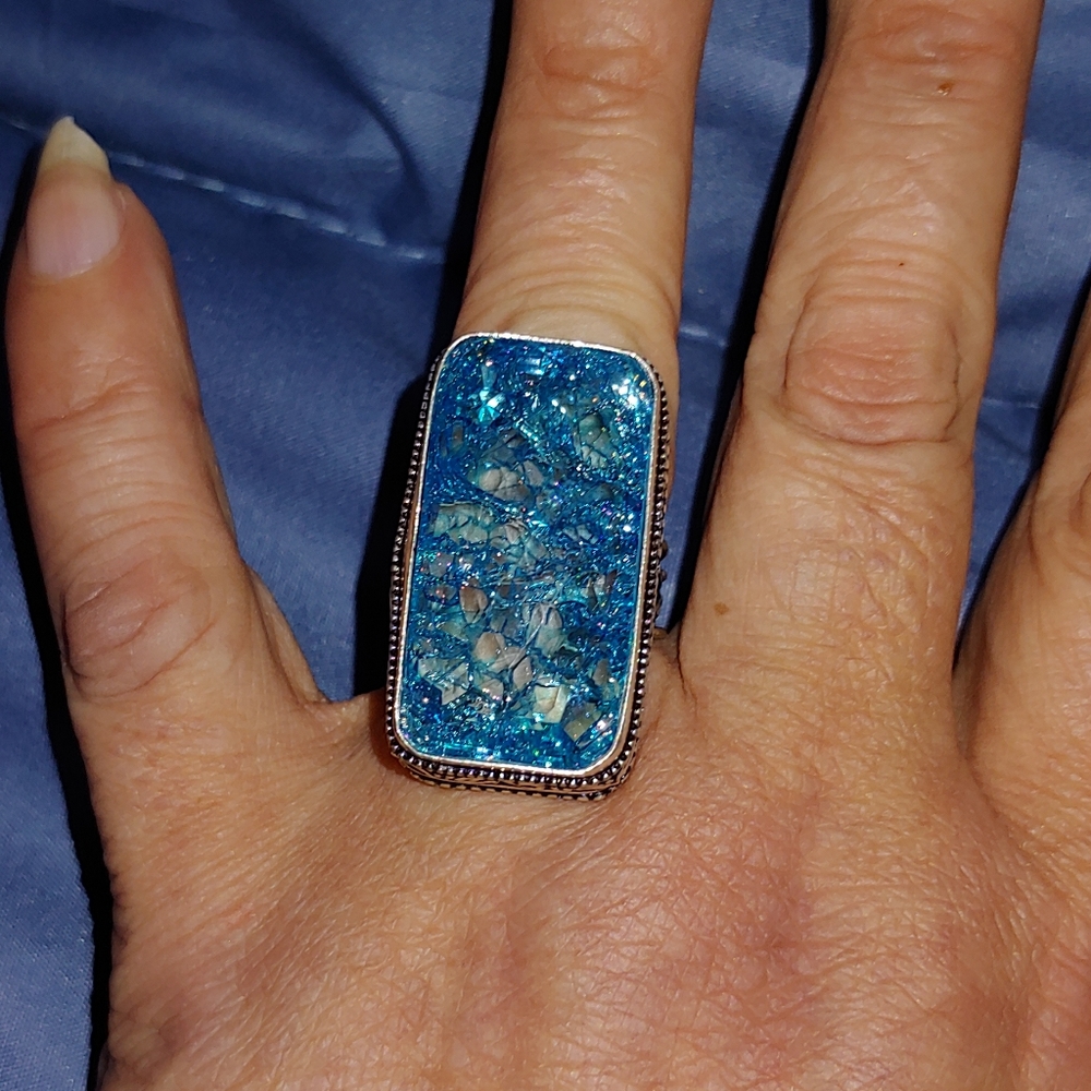 Sparkling multifaceted blue topaz ring